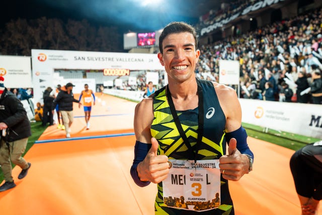 runner celebrating completion of a race with a thirdplace medal