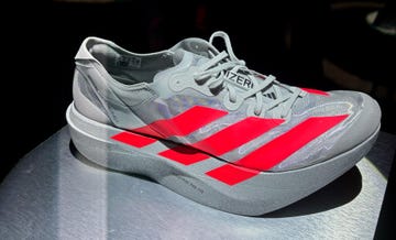 a grey and red striped adidas shoe