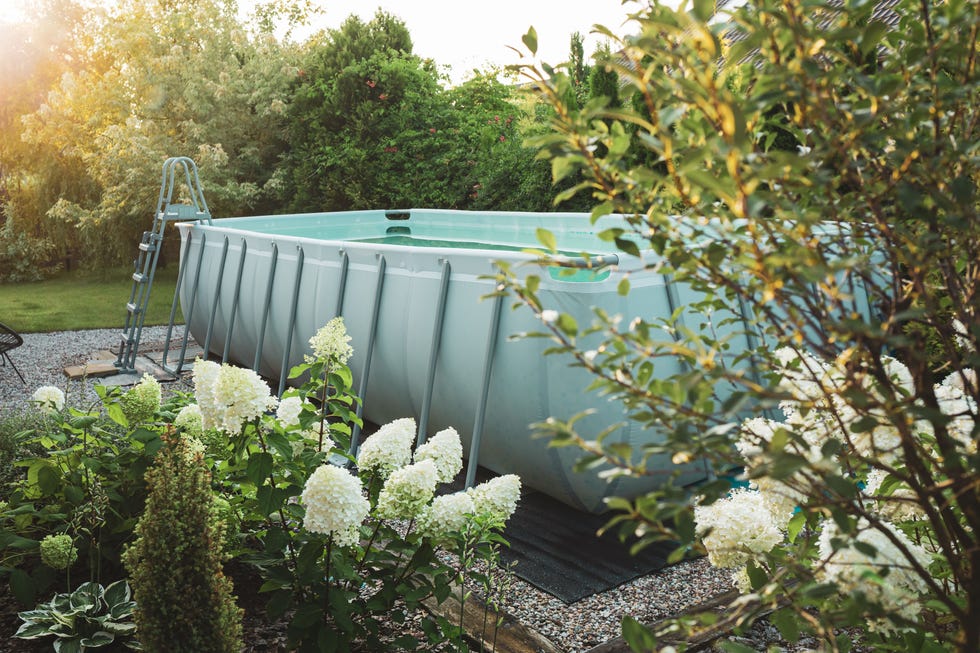 long, above ground, rectangular, rack frame swimming pool outdoor in the beautiful garden nook summer holiday vacation and recreation