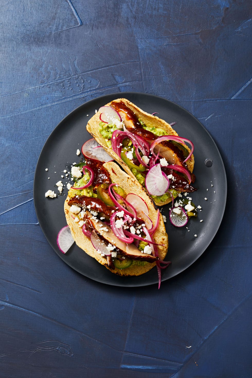 adobo glazed portobello tacos with pickled red onions and radishes served on top
