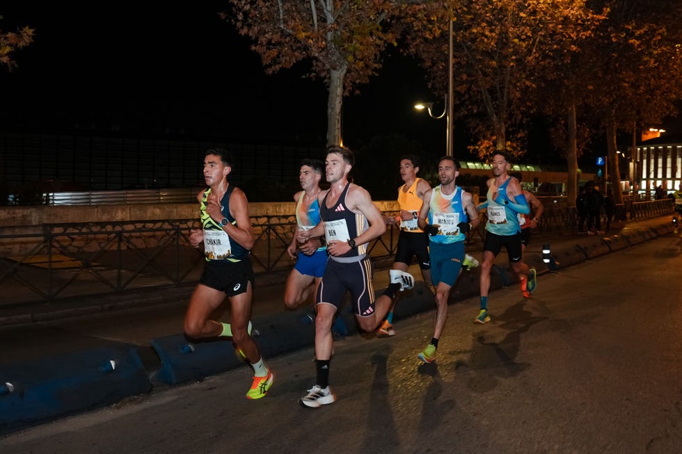 nighttime running event featuring several athletes in motion