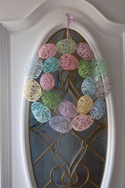 wreath made of pastel string molded into eggs, which adults can make after an alternative easter egg hunt for craft supplies