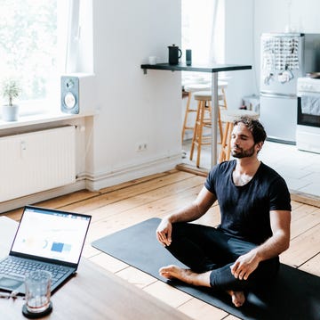 adult man meditates at home office during a break from working