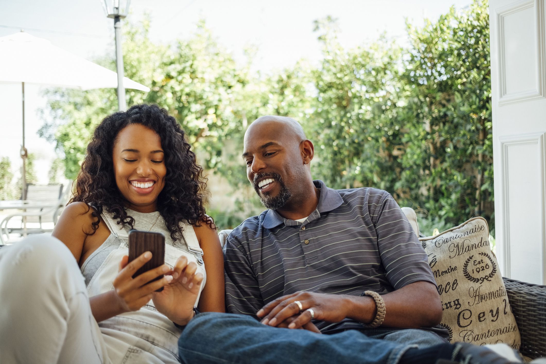 adult siblings looking at smart phone together in royalty free image 1658412981