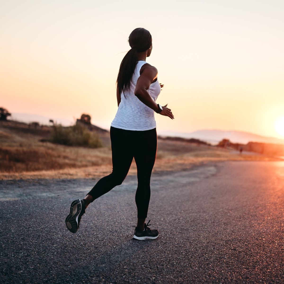 Athletic Woman Runs on the Street during Sunset Stock Image