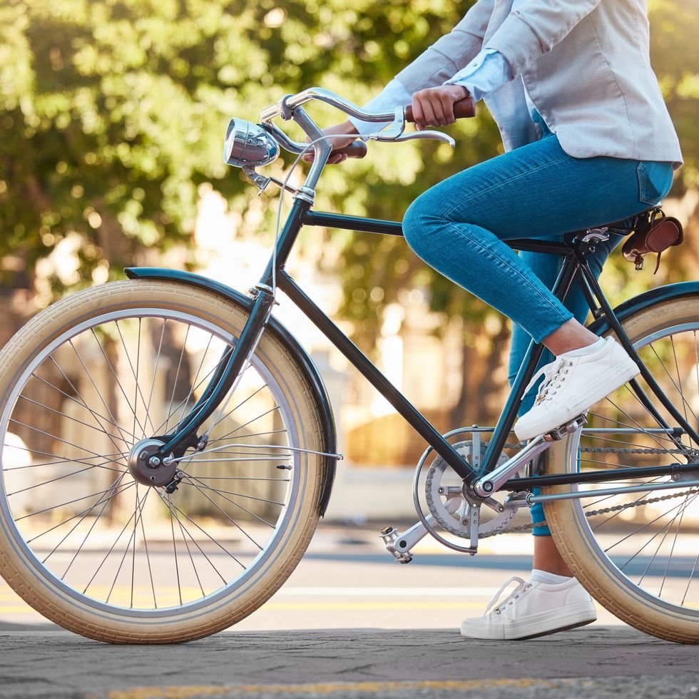 adventure, street travel and bike break outdoor in urban city in summer. woman with vintage bicycle in a road for transport. sustainability person traveling with health mindset or healthy energy