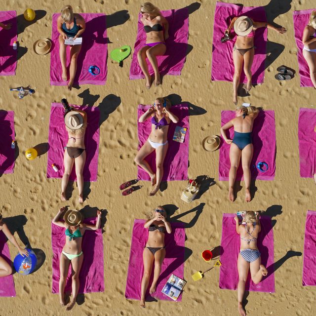 aerial shot of duplicated woman sunbathing on beach