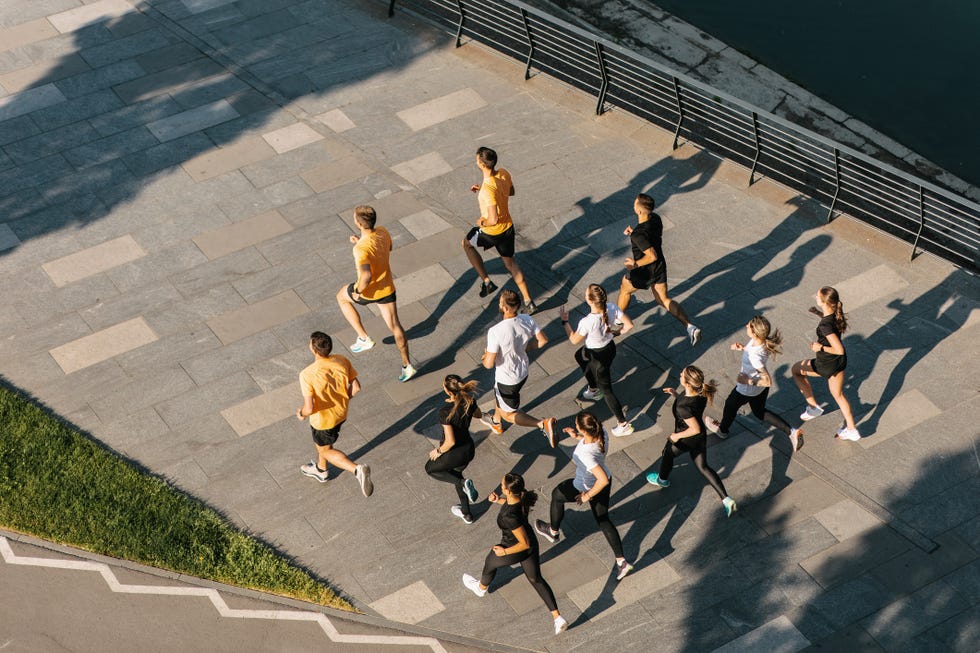 aerial shot of people running on the waterfront