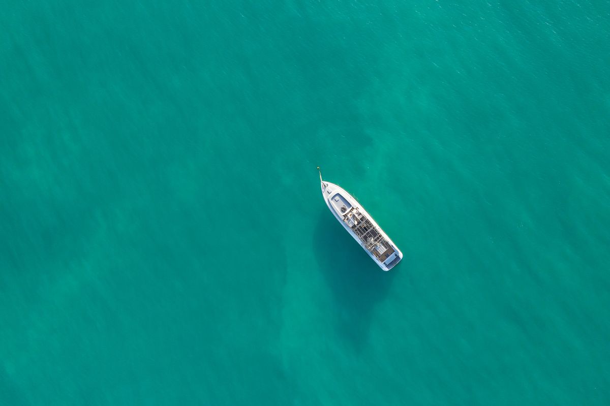Aerial top shot of a luxurious yacht on the sea