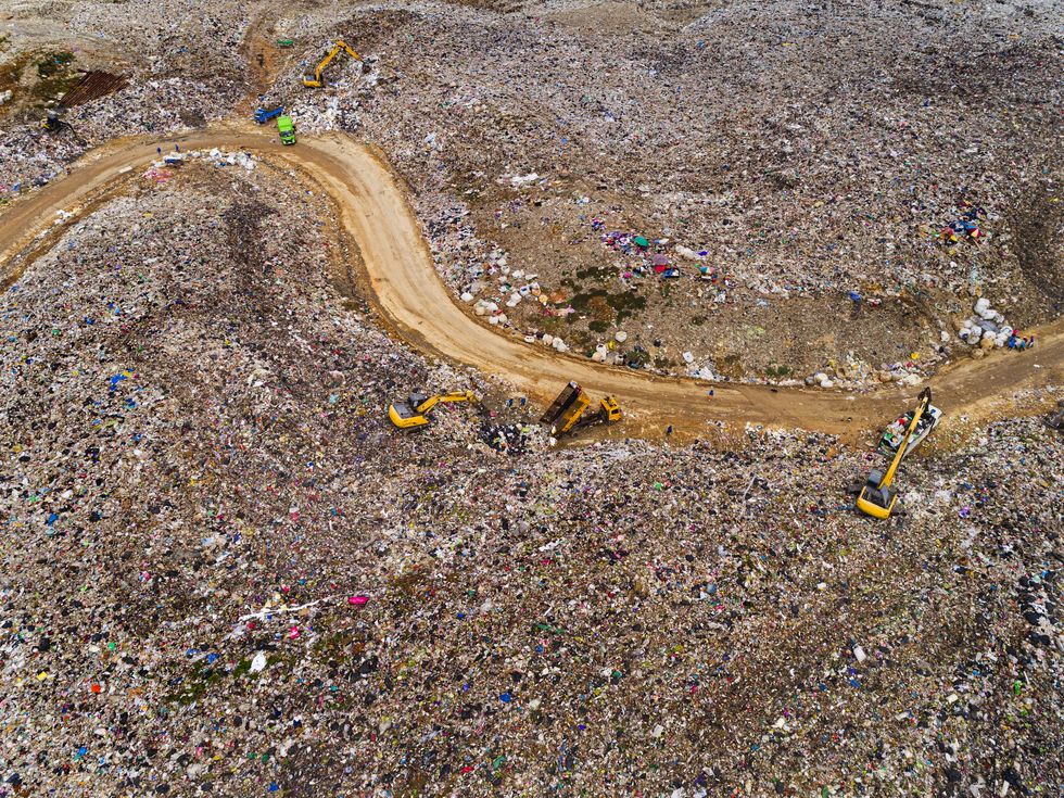 aerial view garbage truck unload garbage to controlled area for waste management or environment reservation