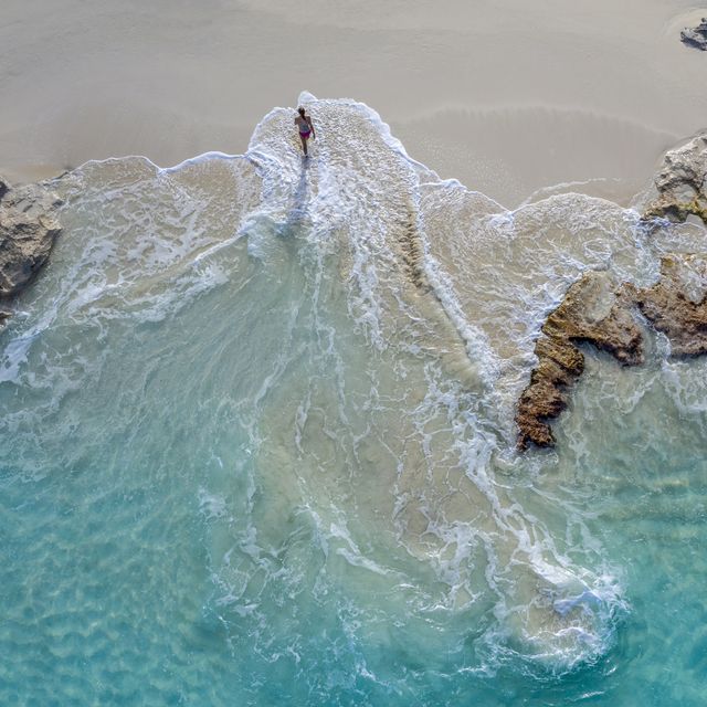 aerial view of a woman walking out of the waterlittle exumaexumabahamas