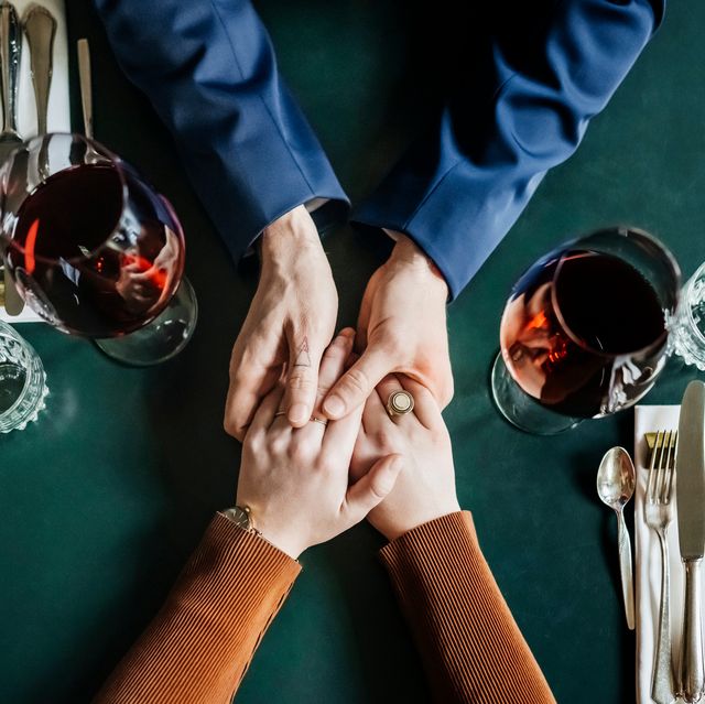 aerial view of couple holding hands at restaurant table
