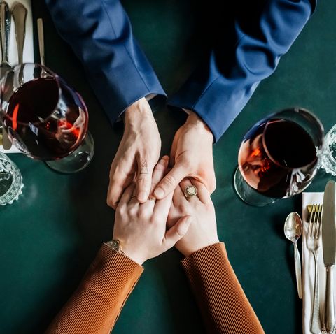 aerial view of couple holding hands at restaurant table