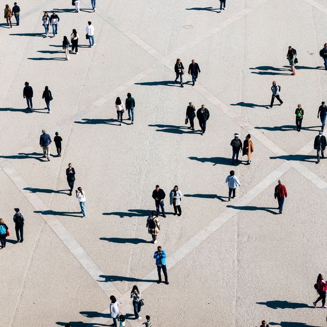 aerial view of large number of people walking on the city square on the sunny day