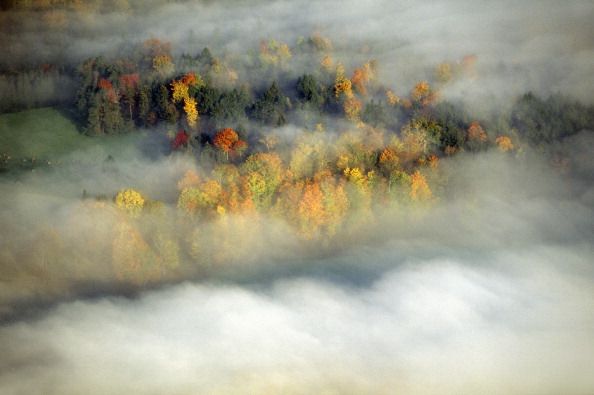 aerial view of morning fog and sunrise in autumn near stowe, vt on scenic route 100