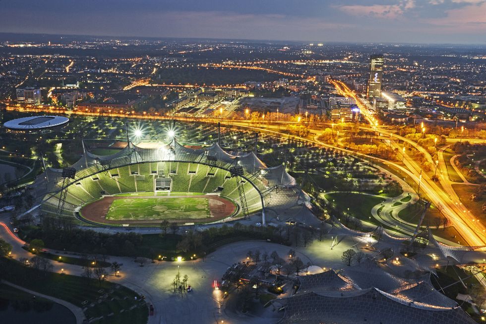 aerial view of munich's olympic stadium illuminated at night