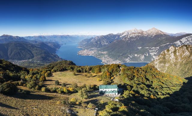 aerial view of rifugio sev with view on the lake como in autumn.