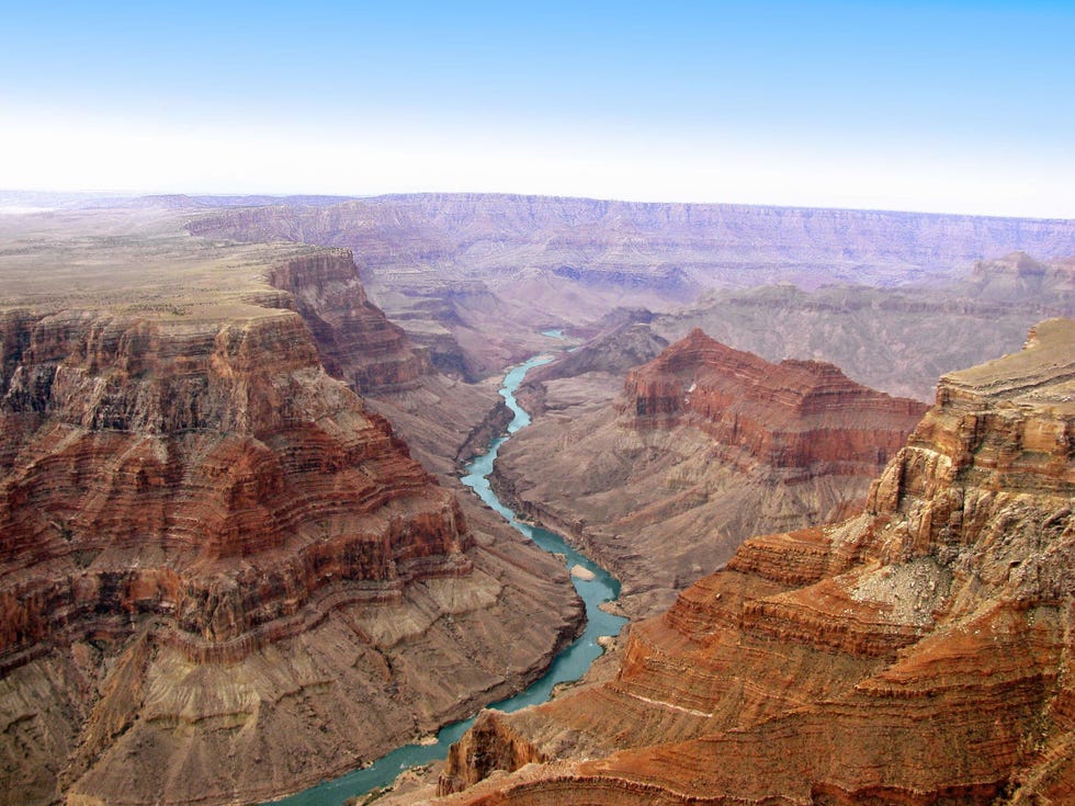 aerial view of river flowing amidst rock formations