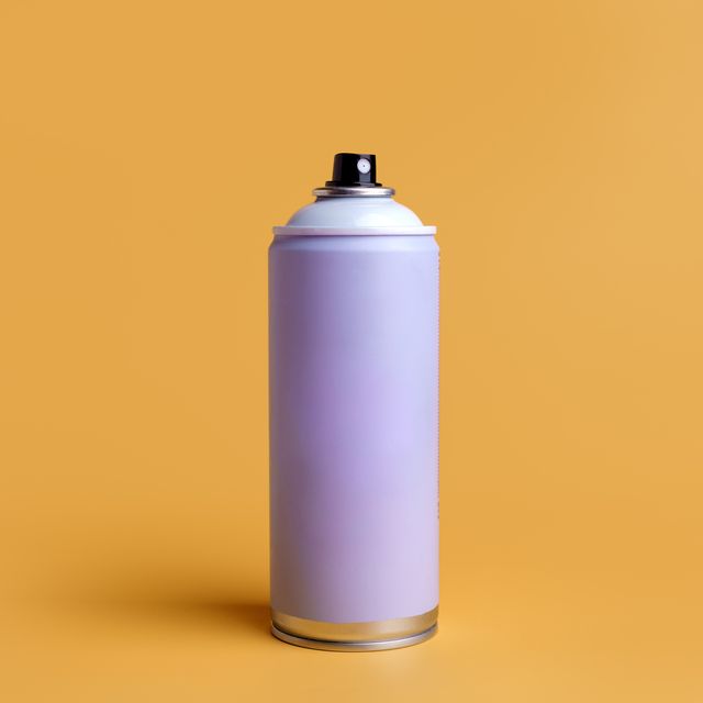 aerosol spray can on yellow background