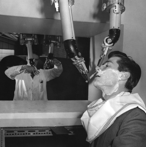 28th february 1959 a man demonstrates the use of new remote handling apparatus, to be used in nuclear research, by shaving another man's beard with the mechanical 'hands' photo by ron casekeystonegetty images