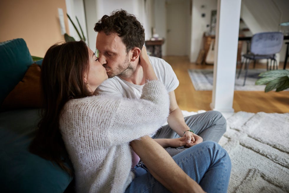 affectionate couple kissing at home