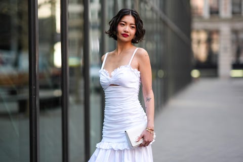 a model wears a white dress during fashion week