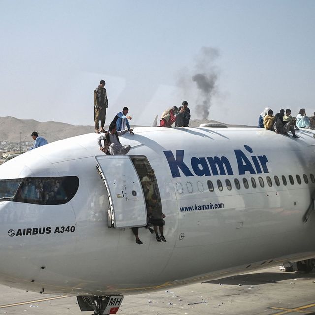 afghan people climb atop a plane as they wait at the kabul airport in kabul on august 16, 2021, after a stunningly swift end to afghanistan's 20 year war, as thousands of people mobbed the city's airport trying to flee the group's feared hardline brand of islamist rule photo by wakil kohsar  afp photo by wakil kohsarafp via getty images