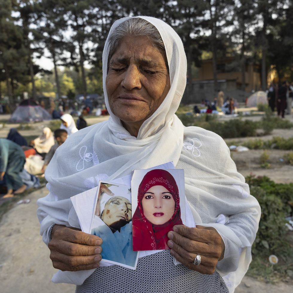 kabul, afghanistan   august 12  zoohra, 60, holds the photo of her daughter who she said was killed by the taliban one month ago at a makeshift idp camp in share e naw park to various mosques and schools on august 12, 2021 in kabul, afghanistan people displaced by the taliban advancing are flooding into the kabul capital to escape the taliban takeover of their provinces photo by paula bronsteingetty images