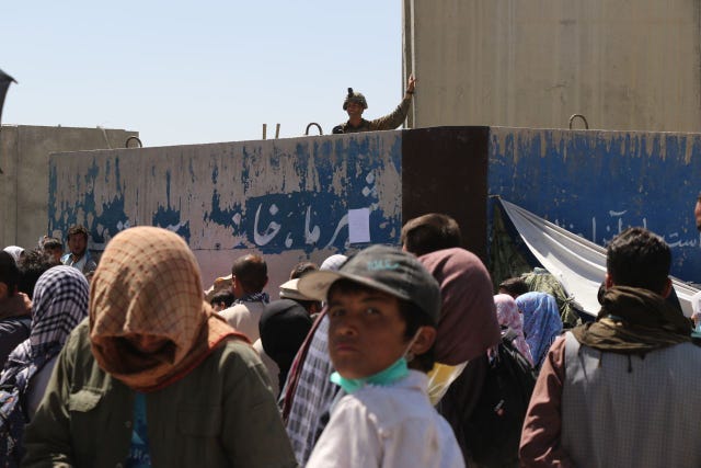 people wait to be evacuated at kabul's hamid karzai airport