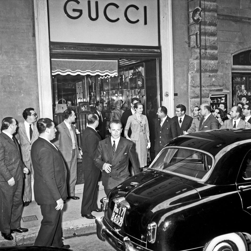 american actress and princess grace kelly leaving the boutique 'gucci', in via dei condotti, surrounded by a crowd of onlookers her husband rainier iii rainier louis henri maxence bertrand grimaldi, prince of monaco, is visible behind her rome, 1959