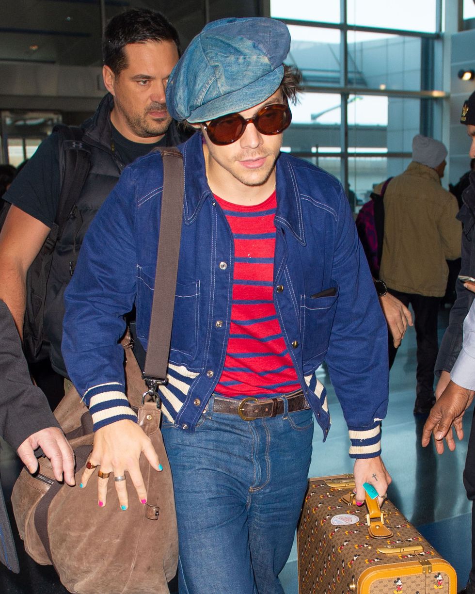 11182019 exclusive a very fashionable harry styles arrives at jfk airport in new york city after hosting saturday night live' the 25 year old english singer and actor had his nails painted pink and blue and was carrying mickey mouse luggage styles also wore a denim cap, striped sweater, blue jacket, bell bottom jeans, and white trainers salestheimagedirectcom please bylinetheimagedirectcomexclusive please email salestheimagedirectcom for fees before use