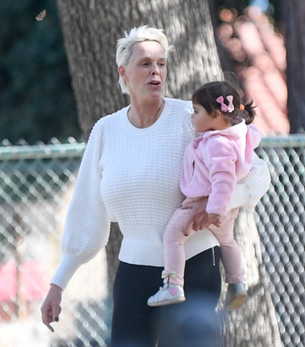 12222019 exclusive brigitte nielsen heads to a park with family in los angeles the 56 year old model and actress held her child while playing a casual game of basketball the multitasking mom could be seen with a pacifier in her mouth at one point  video availablesalestheimagedirectcom please bylinetheimagedirectcomexclusive please email salestheimagedirectcom for fees before use