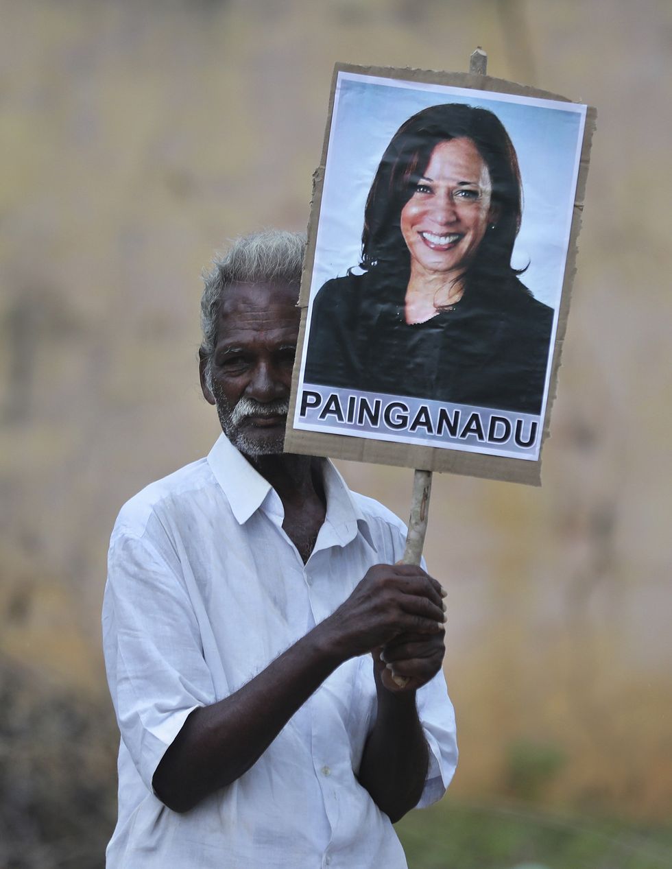 an elderly villager holds a placard of us vice president elect kamala harris during celebrations for her victory in painganadu a neighboring village of thulasendrapuram, the hometown of harris maternal grandfather, south of chennai, tamil nadu state, india, sunday, nov 8, 2020 waking up to the news of kamala harris election as joe bidens running mate, overjoyed people in her indian grandfathers hometown are setting off firecrackers, carrying her placards and offering prayers ap photoaijaz rahi