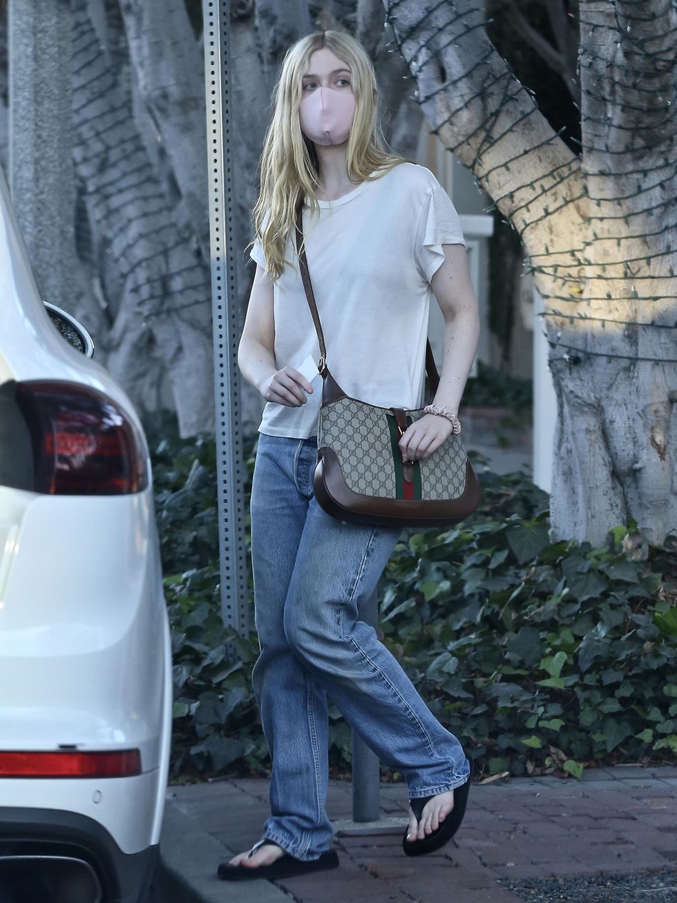 west hollywood, ca    exclusive    elle fanning keeps her ensemble simple with a white tee and jeans while out getting some christmas shopping done in wehopictured elle fanningbackgrid usa 18 december 2020 usa 1 310 798 9111  usasalesbackgridcomuk 44 208 344 2007  uksalesbackgridcomuk clients   pictures containing childrenplease pixelate face prior to publication