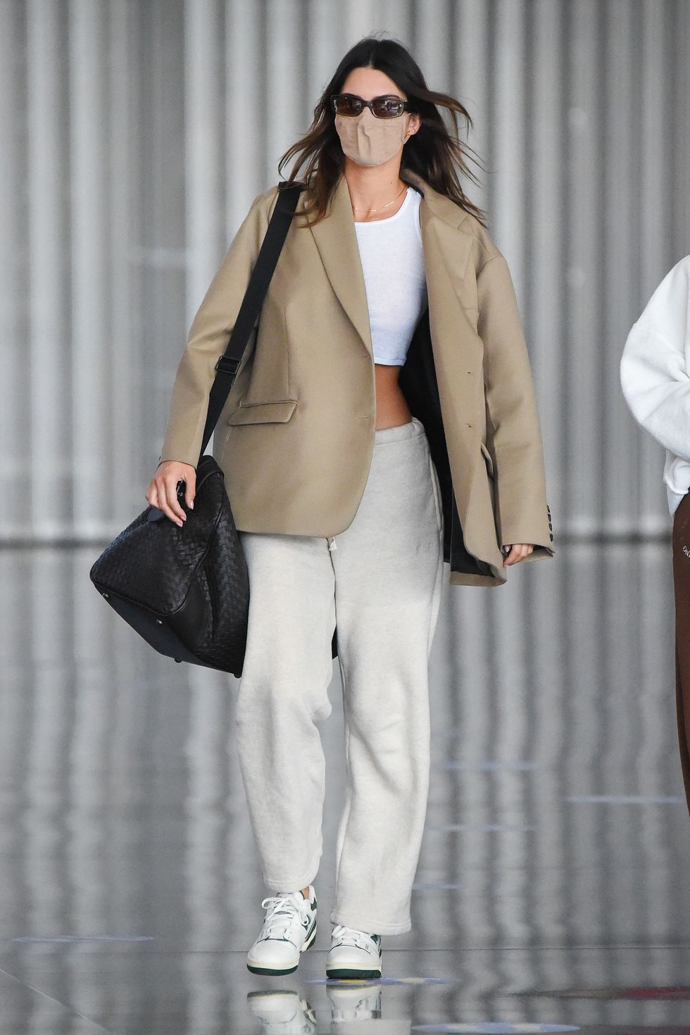 04242021 exclusive kendall jenner is pictured arriving at jfk airport in new york the 25 year old american model looked fresh faced after the overnight flight wearing a large sport coat over over a white crop top paired with beige joggers and white trainers kendall's arrival comes one day after receiving a 5 year restraining order against home intruder and her father caitlyn jenner announcing his run for california governor salestheimagedirectcom please bylinetheimagedirectcomexclusive please email salestheimagedirectcom for fees before use