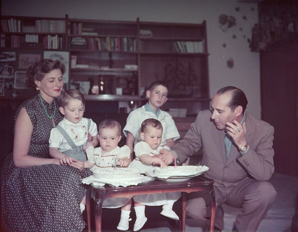 italian movie director roberto rossellini and his wife, actress ingrid bergman, gather around their twins, isabella and ingrid, who are looking at their first birthday cakes during a family celebration in rome, italy on june 18, 1953 the actress holds their first child robertino, while in center background is renzo rossellini, the film directors son by a previous marriage ap photo
