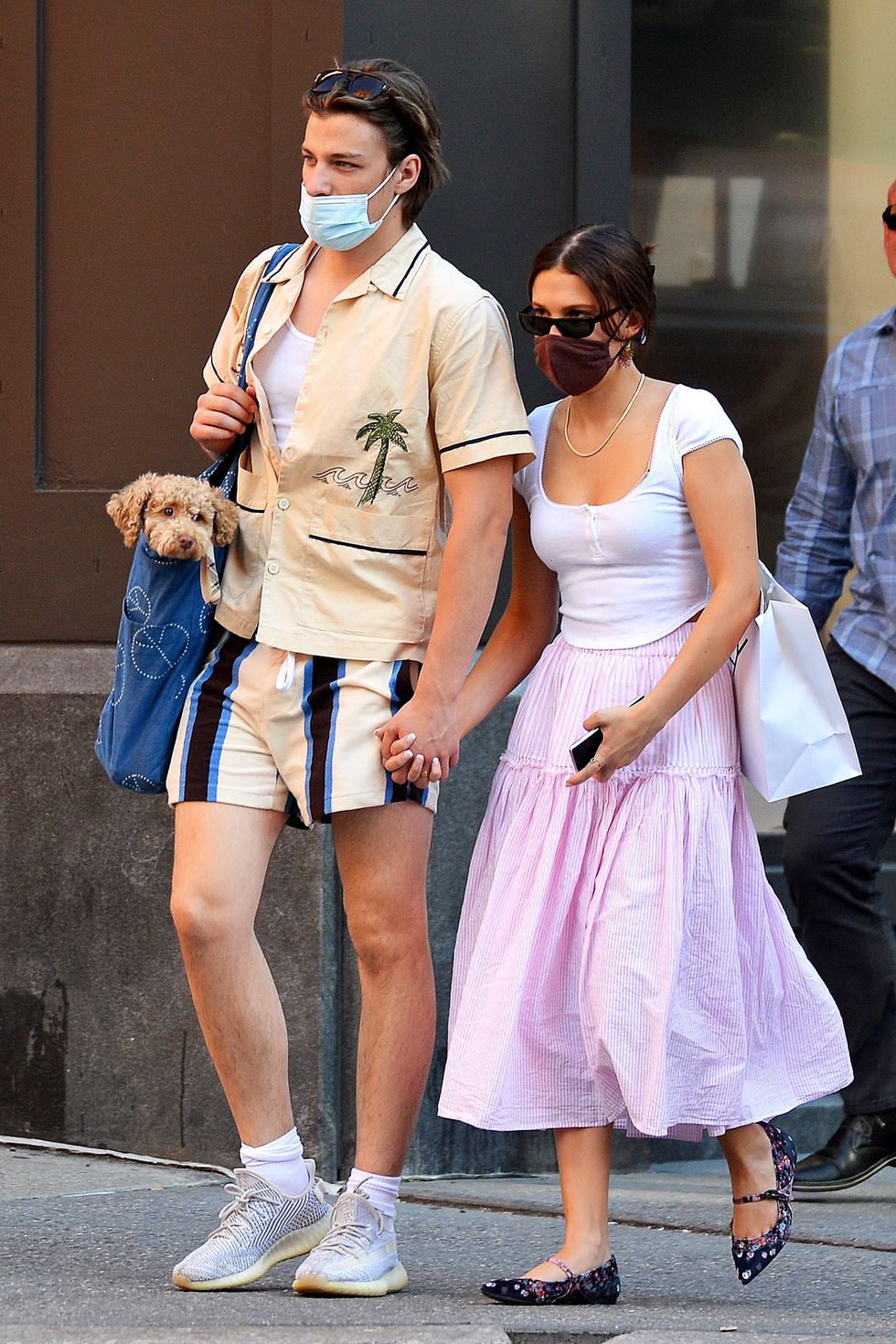 06172021 premium exclusive first pics millie bobby brown and jake bongiovi step out as a couple for the first time in new york city the 'stranger things' star held hands with the son of jon bon jovi while out on a stroll brown carried her pup in a tot and wore a white blouse, pink skirt, and flatssalestheimagedirectcom please bylinetheimagedirectcomexclusive please email salestheimagedirectcom for fees before use