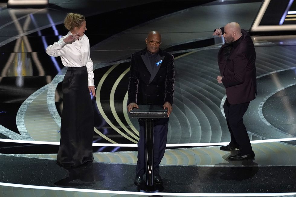 uma thurman, from left, samuel l jackson and john travolta present the award for best performance by an actor in a leading role at the oscars on sunday, march 27, 2022, at the dolby theatre in los angeles ap photochris pizzello