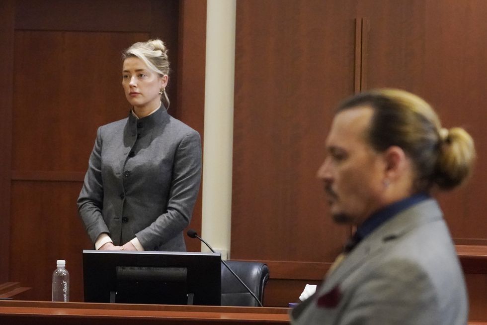 actors amber heard and johnny depp watch as the jury leaves the courtroom at the end of the day at the fairfax county circuit courthouse in fairfax, va, monday, may 16, 2022 depp sued his ex wife heard for libel in fairfax county circuit court after she wrote an op ed piece in the washington post in 2018 referring to herself as a public figure representing domestic abuse ap photosteve helber, pool