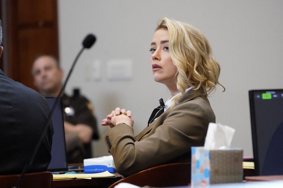 actor amber heard listens in the courtroom during actor and her ex husband johnny depps defamation case against her, in the courtroom at the fairfax county circuit courthouse in fairfax, virginia, us, may 23, 2022 steve helberpool via reuters