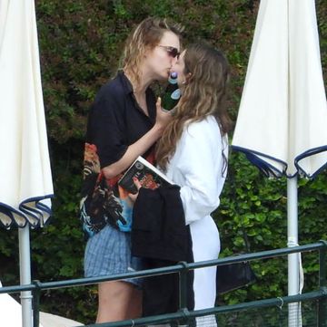 cara delevingne, wearing a t shirt with bob marleys picture, seen kissing a female friend in the park of hotel splendido in portofino 07 jun 2022 pictured cara delevingne photo credit oliver palombi  mega themegaagencycom 1 888 505 6342