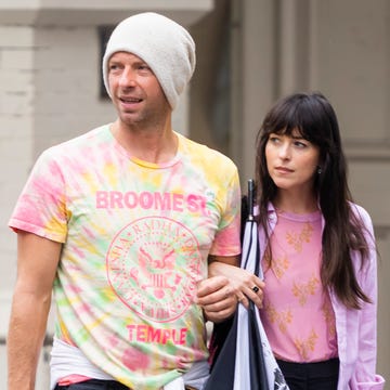 06072022 exclusive chris martin and dakota johnson step out for a stroll in new york city the 45 year old english singer songwriter and his 32 year old actress girlfriend walked through trendy soho arm in arm before they were approached by a fan where chris presented her with a pin that said "love" before the couple continued on keeping close to one anothersalestheimagedirectcom please bylinetheimagedirectcomexclusive please email salestheimagedirectcom for fees before use