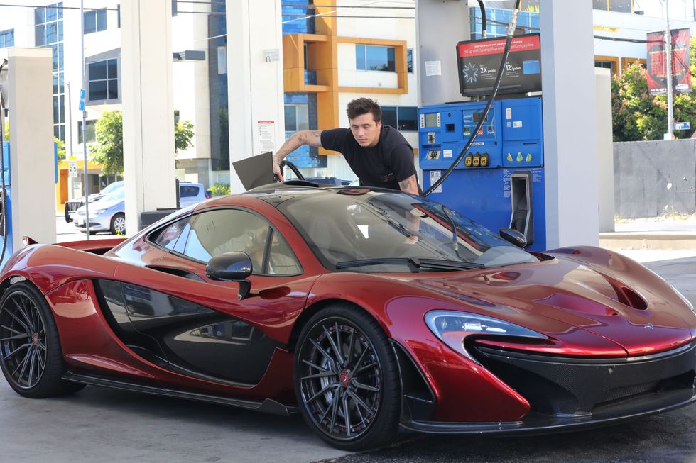 08132022 exclusive brooklyn beckham is pictured gassing up his is mclaren supercar in los angeles the 23 year old english model and photographer was dressed casually in a black tee shirt paired with denim jeans and black loafers recently married to actress nicola peltz brooklyn showed off some new ink on his left hand with reads "married" salestheimagedirectcom please bylinetheimagedirectcomexclusive please email salestheimagedirectcom for fees before use