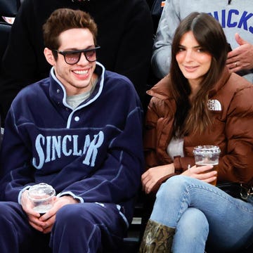 a man and woman sitting on a bench