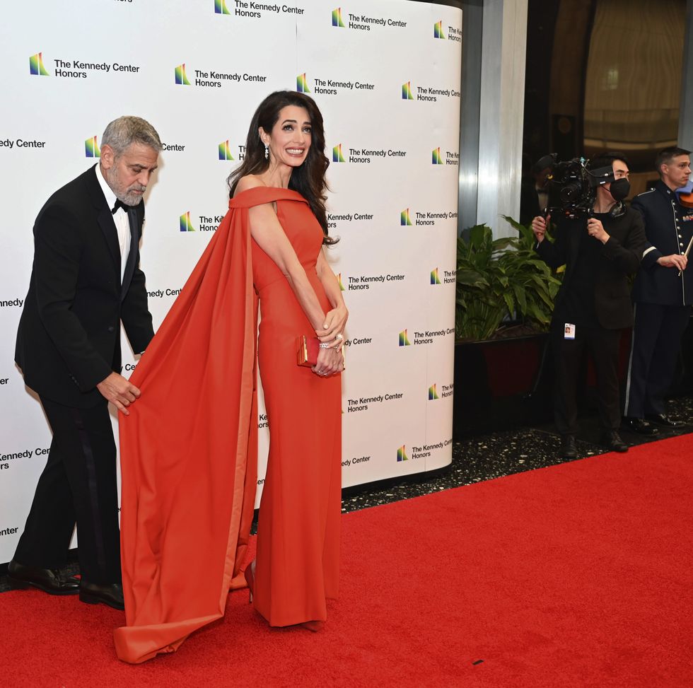 2022 kennedy center honoree actor george clooney assists his wife, amal clooney, after arriving at the state department for the kennedy center honors gala dinner, saturday, dec 3, 2022, in washington ap photokevin wolf