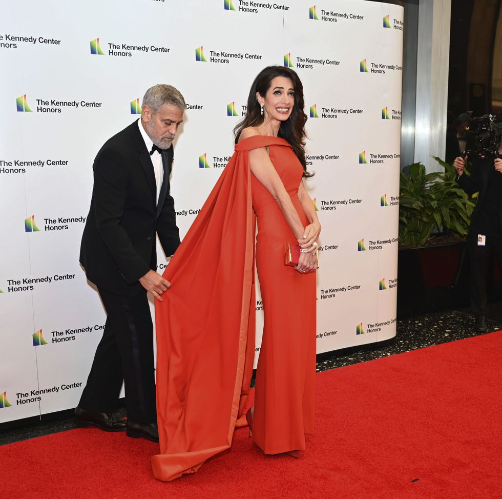 2022 kennedy center honoree actor george clooney assists his wife, amal clooney, after arriving at the state department for the kennedy center honors gala dinner, saturday, dec 3, 2022, in washington ap photokevin wolf