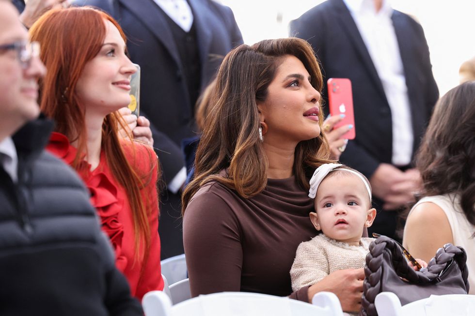 priyanka chopra holds her and nick jonas daughter, malti, as sophie turner, joe jonas wife looks on, during the ceremony where the jonas brothers will unveil their star on the hollywood walk of fame in los angeles, california, us, january 30, 2023 reutersmario anzuoni