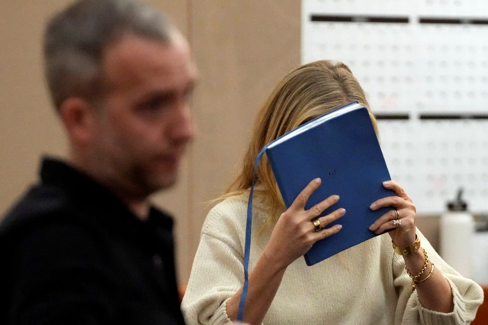 actor gwyneth paltrow covers her face with a blue notebook as she leaves a courtroom where she is accused in a lawsuit of crashing into a skier during a 2016 family ski vacation, leaving him with brain damage and four broken ribs, in park city, utah, march 21, 2023 rick bowmerpool via reuters