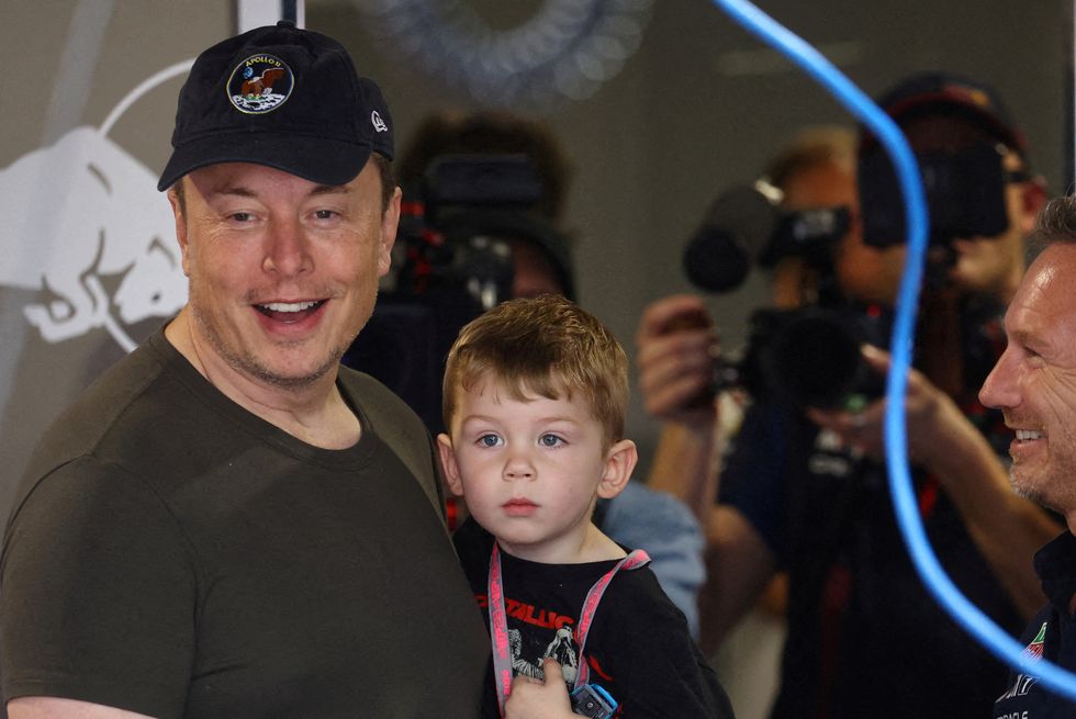 formula one f1 miami grand prix miami international autodrome, miami, florida, us may 6, 2023 elon musk holds his son with red bull team principal christian horner in the garage before practice reutersmike segar