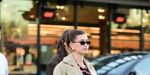 01162024 hailey bieber is spotted exiting erewhon market in los angeles the 27 year old american model wore a long beige trench coat over a blue and red sweater paired with distressed denim jeans and redleather loaferssalestheimagedirectcom please bylinetheimagedirectcom